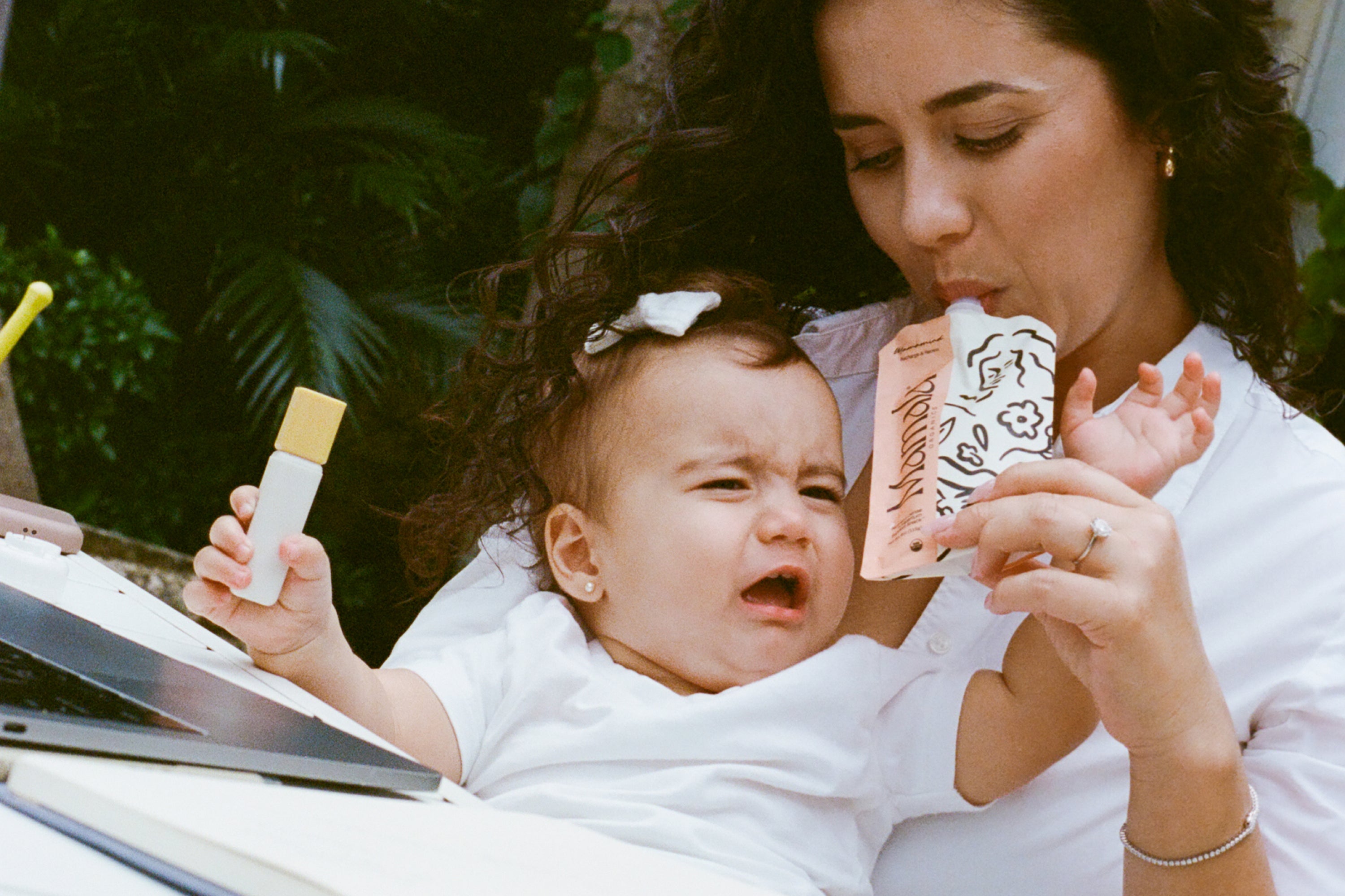 Postpartum mom holding Mamamind snack pouch – clarity and energy support