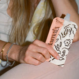 Postpartum mom holding Mamamind snack pouch – clarity and energy support